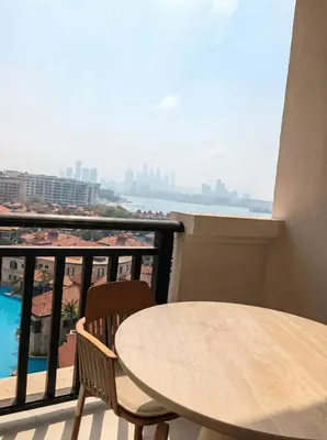 a table and chairs on a balcony with a view at Palm Horizon | Luxury Anantara Studio in Dubai
