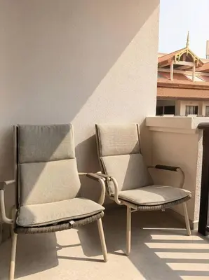 two chairs sitting on a balcony next to a building at Palm Horizon | Luxury Anantara Studio in Dubai