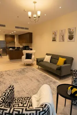 a living room with a couch and a table at Skyline Escape | Marina High-Floor 1BR Apartment in Dubai