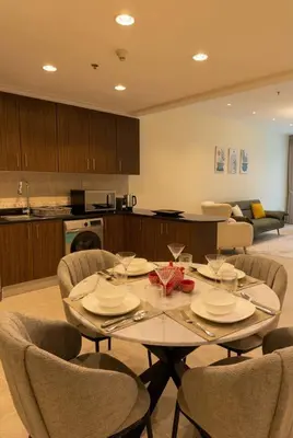 a dining room with a table and chairs in a kitchen at Skyline Escape | Marina High-Floor 1BR Apartment in Dubai