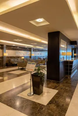 a lobby with a couch and a table in a building at Skyline Escape | Marina High-Floor 1BR Apartment in Dubai