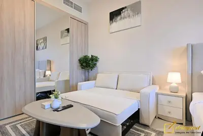a room with a bed and a table and a mirror at Luxury Studio in Dubai Hills by Deleguest in Dubai