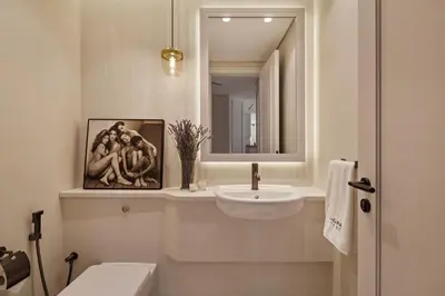 a white bathroom with a sink and a mirror at Sky-high luxury in DIFC I new and modern in Dubai