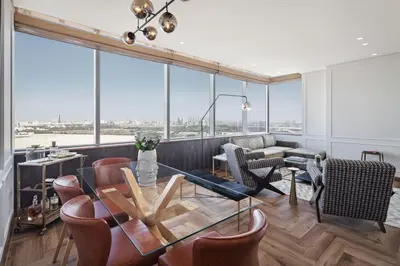 a dining room with a glass table and chairs at Sky-high luxury in DIFC I new and modern in Dubai