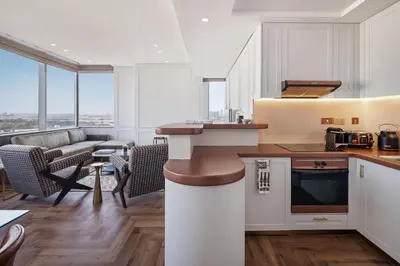 a kitchen and living room with a couch at Sky-high luxury in DIFC I new and modern in Dubai