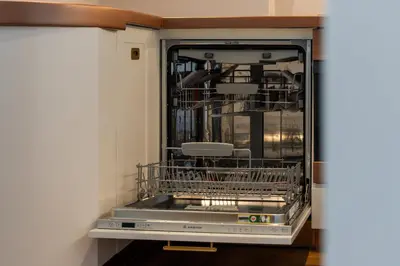 a dishwasher in a kitchen with two dishes in it at Sky-high luxury in DIFC I new and modern in Dubai