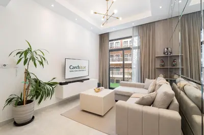 a living room with a couch and a tv at Luxury 1BR Apartment in Binghatti Mirage JVC Dubai in Dubai