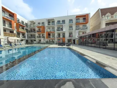an empty swimming pool in the middle of a building at Luxury 1BR Apartment in Binghatti Mirage JVC Dubai in Dubai