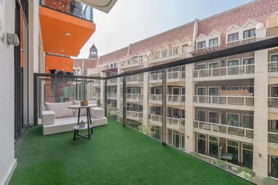 a balcony with green flooring in a building at Luxury 1BR Apartment in Binghatti Mirage JVC Dubai in Dubai