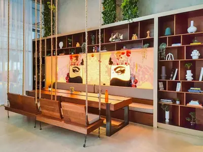 a room with a table and shelves with vases at Stunning 1 B R in Dubai Hills in Dubai