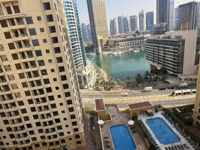 a view of a river between two tall buildings at Jumeirah Beach Luxury Collective in Dubai