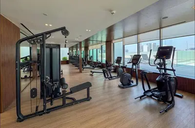 a gym with treadmills and exercise equipment in a building at Studio in JVC I Pool View I Near Mall & Dining in Dubai