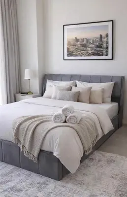 a bedroom with a large bed with towels on it at Elegant JVC Studio I Gym Access I Prime Location in Dubai