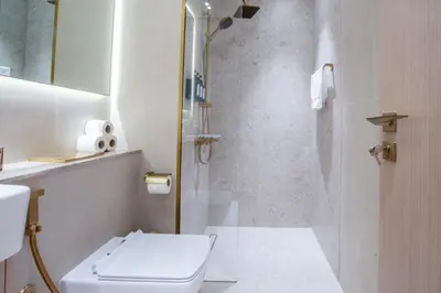 a bathroom with a shower with a toilet and a sink at Elegant JVC Studio I Gym Access I Prime Location in Dubai