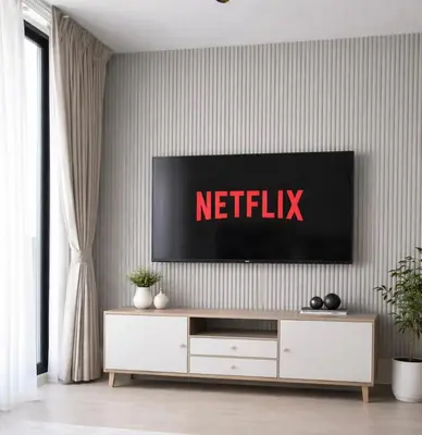 a living room with a netflix tv on a wall at Elegant JVC Studio I Gym Access I Prime Location in Dubai