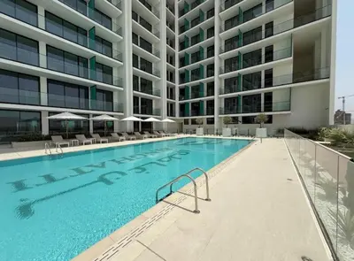 a swimming pool in front of a building at Elegant JVC Studio I Gym Access I Prime Location in Dubai
