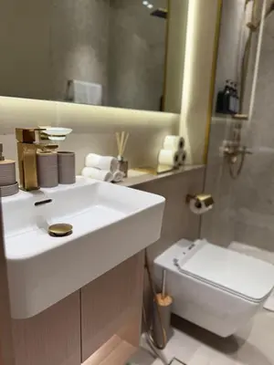 a bathroom with a white sink and a toilet at Stylish 2Bedroom JVC I Comfort I Epic Pool in Dubai