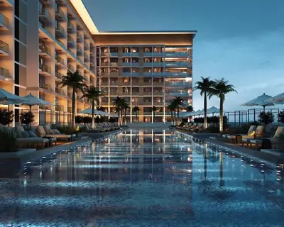 a hotel with a swimming pool in front of a building at Stylish 2Bedroom JVC I Comfort I Epic Pool in Dubai