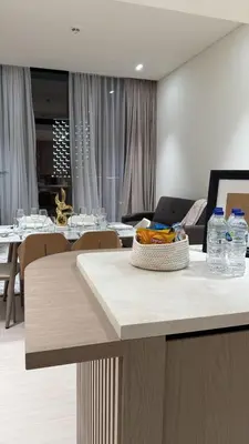 a kitchen with a table with bottles of water on it at Stylish 2Bedroom JVC I Comfort I Epic Pool in Dubai