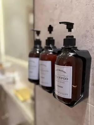 a group of four bottles of soap on a wall at Stylish 2Bedroom JVC I Comfort I Epic Pool in Dubai