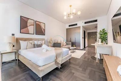 a bedroom with a bed and a living room at Tranquil Studio Just minutes Drive to Dubai Attraction, O10 Building Al Jaddaf by Deluxe Holiday Homes in Dubai