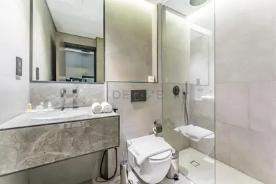 a bathroom with a sink and a toilet and a shower at Tranquil Studio Just minutes Drive to Dubai Attraction, O10 Building Al Jaddaf by Deluxe Holiday Homes in Dubai