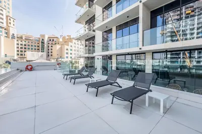 a row of chairs on the roof of a building at Tranquil Studio Just minutes Drive to Dubai Attraction, O10 Building Al Jaddaf by Deluxe Holiday Homes in Dubai