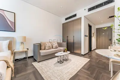 a living room with a couch and a table at Tranquil Studio Just minutes Drive to Dubai Attraction, O10 Building Al Jaddaf by Deluxe Holiday Homes in Dubai