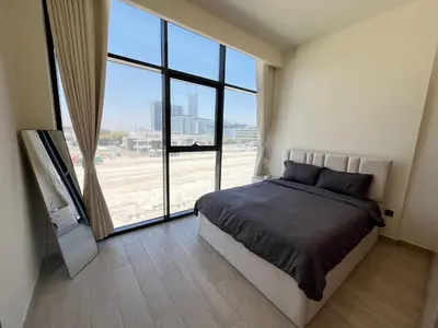 a bedroom with a bed and a large window at Chic French-Riviera Vibe - Burj View 1BR in Dubai