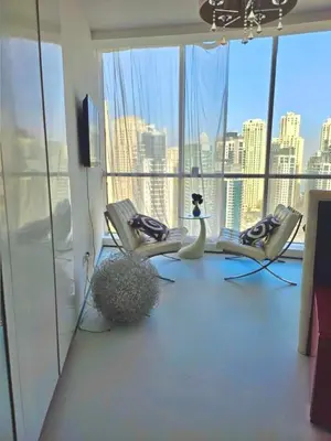 a room with two chairs and a television in a building at Vip guestroom 360 view of marina private terrace with pool in Dubai