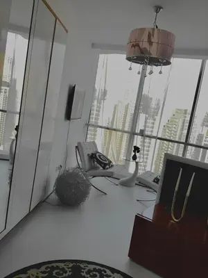 an office with a desk with a computer and a phone at Vip guestroom 360 view of marina private terrace with pool in Dubai