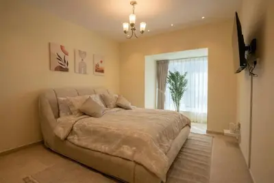 a bedroom with a bed and a television in it at High-Floor Marina 1BR Apartment | Skyline Views in Dubai
