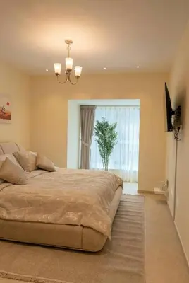 a bedroom with a large bed and a window at High-Floor Marina 1BR Apartment | Skyline Views in Dubai
