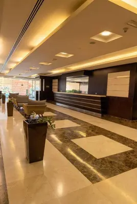 a lobby with couches and tables in a building at High-Floor Marina 1BR Apartment | Skyline Views in Dubai