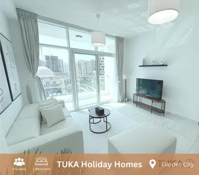 a living room with a white couch and a television at 1-BHK - Brand New Building - Spacious - Central in Dubai