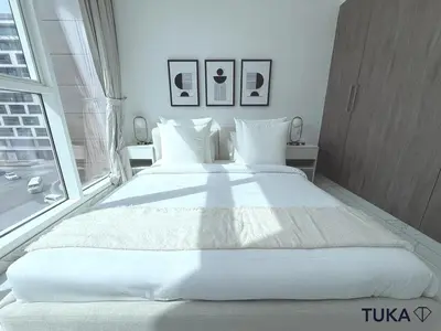 a large white bed in a room with a window at 1-BHK - Brand New Building - Spacious - Central in Dubai