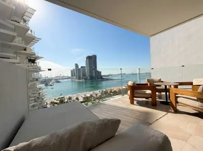 a living room with a large window with a view of the city at FIVE Palm | Stunning Sea-View Luxury 2BR Apartment in Dubai