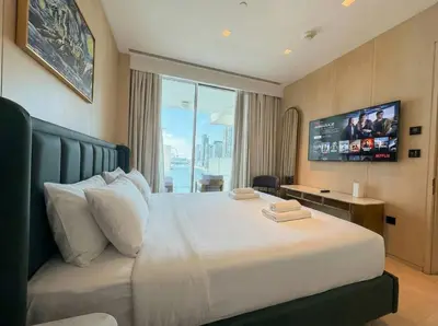 a bedroom with a large bed with a tv on the wall at FIVE Palm | Stunning Sea-View Luxury 2BR Apartment in Dubai