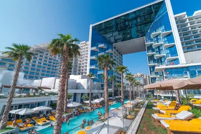 a resort with a pool and palm trees and a building at FIVE Palm | Stunning Sea-View Luxury 2BR Apartment in Dubai