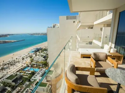 a balcony with a view of a beach and the ocean at FIVE Palm | Stunning Sea-View Luxury 2BR Apartment in Dubai