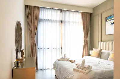 a bedroom with a large bed with towels on it at 1BR Burj View Apartment In Dubai Creek Harbour in Dubai