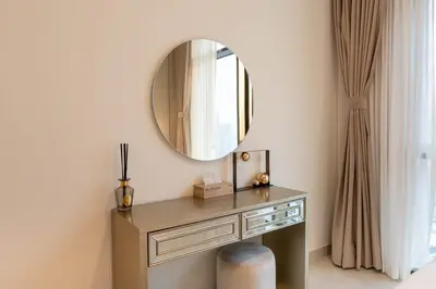 a dressing table with a mirror in a room at 1BR Burj View Apartment In Dubai Creek Harbour in Dubai