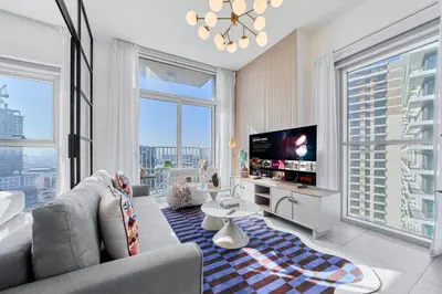 a living room with a couch and a tv at Smart & Elegant 2BR in Collective Dubai Hills in Dubai