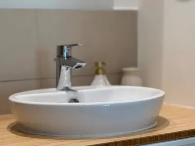 a white sink with a faucet on a counter at Smart & Elegant 2BR in Collective Dubai Hills in Dubai
