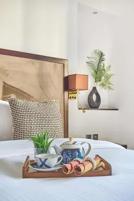 a tray with a tea set on a bed at Frank Porter - Elite Downtown Residence 1 in Dubai
