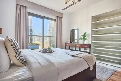 a bedroom with a large bed and a large window at Frank Porter - Elite Downtown Residence 1 in Dubai