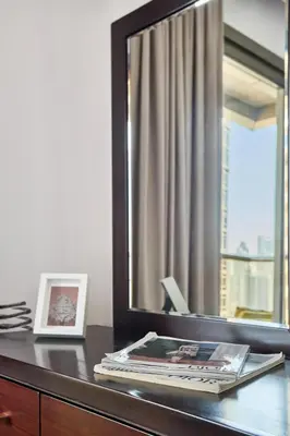 a desk with a mirror and a picture on it at Frank Porter - Elite Downtown Residence 1 in Dubai