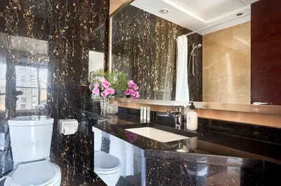 a black bathroom with a toilet and a sink at Frank Porter - Elite Downtown Residence 1 in Dubai
