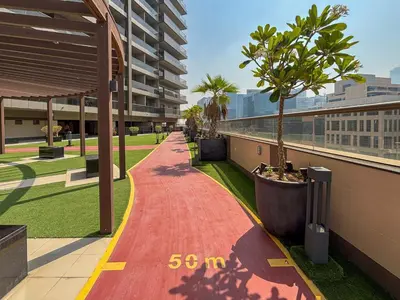 a red walkway with a palm tree on a building at Frank Porter - Elite Downtown Residence 1 in Dubai
