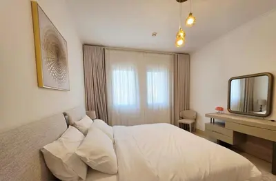 a bedroom with a bed and a desk and a mirror at Yansoon 3 Downtown, Dubai in Dubai